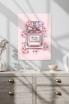 a pink perfume bottle with flowers on it