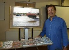 a man standing in front of a tv holding a tray with food on top of it