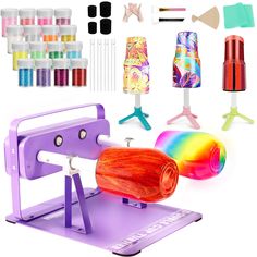 an assortment of crafting supplies are displayed on a white background, including a machine