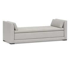 a gray couch sitting on top of a white floor