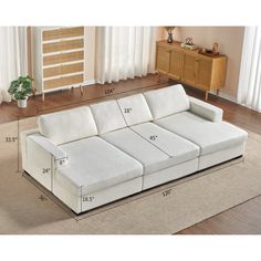 a white couch with measurements for it