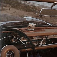 the interior of an old car with its dashboard and steering wheel