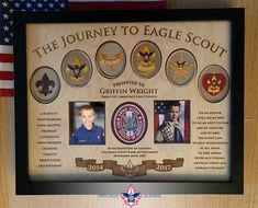 an eagle scout plaque is displayed in front of the american flag and other memorabilia on display