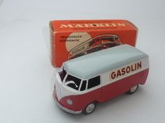 a red and white toy bus next to a box