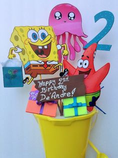 spongebob birthday cake topper and decorations in a trash can with the number 2 on it