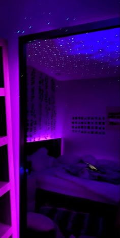 a bed room with a large mirror and purple lights