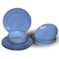 a set of blue plates and bowls on a white background