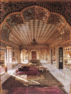 an ornately decorated room with couches and mirrors