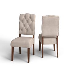 a pair of beige chairs sitting next to each other on top of a white floor