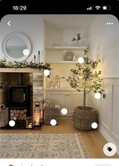 a living room filled with furniture and a fire place next to a tree on top of a rug