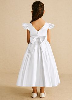 If you are looking for a classic dress for your girl, look no further. Violetta is our adorable satin ballgown dress. She features flutter cap sleeves, a V-back, and a ruched skirt with a bow tie back belt. Satin Flower Girl Dresses, Petal Flower Girl Dress, Ivory Ball Gown, Satin Ballgown, Tea Length Flower Girl Dress, Ballgown Dress, Satin Flower Girl Dress, White Ball Gowns, Ivory Flower Girl