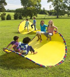 children playing on a large yellow playground slide