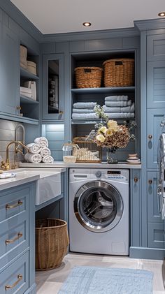 a washer and dryer in a room with blue cabinets