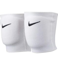 two white knee pads with black nike logo