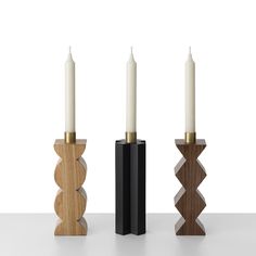 three wooden candlesticks sitting next to each other