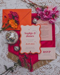 an orange and pink wedding suite with flowers