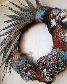 a wreath made out of feathers on the front door