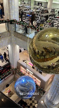 an aerial view of the interior of a shopping mall with christmas decorations and people walking around