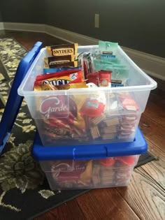 a plastic container filled with snacks on top of a wooden floor