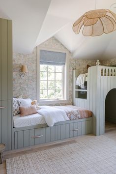 a bed sitting under a window in a bedroom