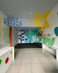 the interior of a brightly colored building with white tiled flooring and walls painted in bright colors