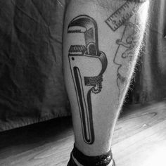 a black and white photo of a man's leg with a tattoo on it