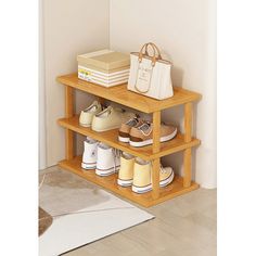 a wooden shelf with shoes and bags on it next to a white rug in a room