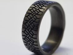 an image of a black ring with tire treads on the outside and inside it