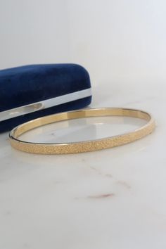 "Vintage Monet Gold Bangle Bracelet. Diameter: 2 5/8\" Width: 4mm Marked: Monet L Inner Circumference: 8\" Condition: discolored Back to the shop: https://www.etsy.com/shop/SusVintage?ref=hdr_shop_menu Don't hesitate to contact me if you have any further questions. Thank you!!" Gold Hinged Jewelry As Gift, Hinged Gold Jewelry As A Gift, Adjustable Gold Bangle Bracelet For Anniversary, Adjustable Hinged Gold Bangle, Adjustable Hinged Bangle Jewelry, Gold Hinged Bangle As Gift, Gold Hinged Bangle For Gift, Gold Hinged Bracelet As A Gift, Gold Hinged Bracelets As A Gift