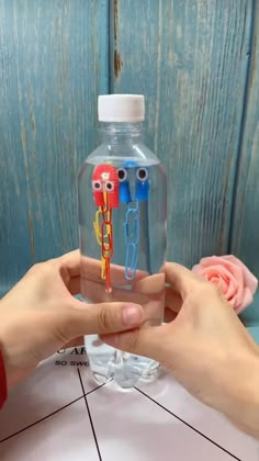 two toothbrushes sticking out of a water bottle