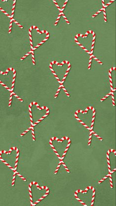 candy canes are arranged in the shape of x on a green background with red and white stripes