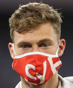 a man wearing a red and white face mask