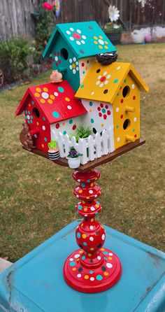 a colorful bird house on top of a blue table