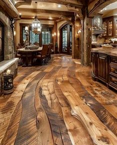 a large kitchen with wood floors and wooden cabinets