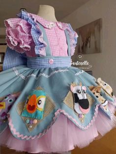 a dress made to look like a child's doll with pictures on the front