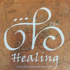 there is a sticker with the word healing in white ink on brown marble