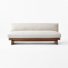 a white couch sitting on top of a wooden frame