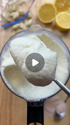 a blender filled with ice cream next to sliced lemons