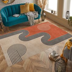 a living room with a blue couch and orange rug on top of wooden flooring