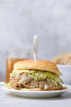 a close up of a sandwich on a plate with a toothpick in it