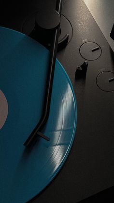 a blue record player sitting on top of a table