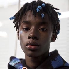 a close up of a person with dreadlocks