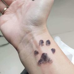 a small paw print on the wrist is shown in black ink, and it looks like an animal's face