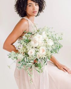 a woman holding a bouquet of flowers in her hands