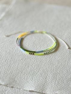 three bracelets sitting on top of a white sheet