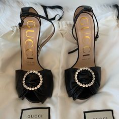 Brand New Never Worn Gucci Black Leather And Crystal Embellished Bow Ilse Sandals Size 36 Come With Dust Bags Overall Condition: Brand New Designer: Gucci Material: Black Leather Includes: Dust Bags Origin: Italy Heel Height: 4.25" Sole: Leather Heel To Toe Length: 9.3" L Approx. Closure/Opening: Adjustable Ankle Wrap Buckle Gemstones: Crystals Size: 36 Gucci Party Heels With Buckle Closure, Gucci Open Heel Sandals For Evening, Gucci Sandals With Heel Strap For Formal Occasions, Gucci Ankle Strap Sandals For Formal Occasions, Gucci Formal Sandals With Heel Strap, Formal Gucci Sandals With Heel Strap, Luxury Gucci Evening Sandals, Gucci Black Heels With Buckle Closure, Gucci Calf Leather Sandals For Evening Wear