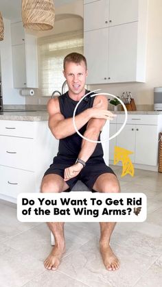 a man sitting on top of a kitchen counter next to a white refrigerator freezer with the caption do you want to get rid of the bat wing arms?