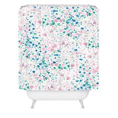 a shower curtain with multicolored dots on it and white base, in the shape of hearts