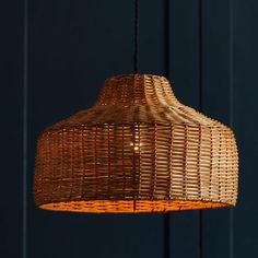 a wicker light hanging from a ceiling with blue walls in the backround