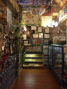 a store filled with lots of items and pictures on the wall above it's shelves